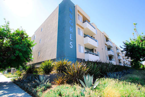 Exterior front of building showing landscaping and freshly painted building colors.