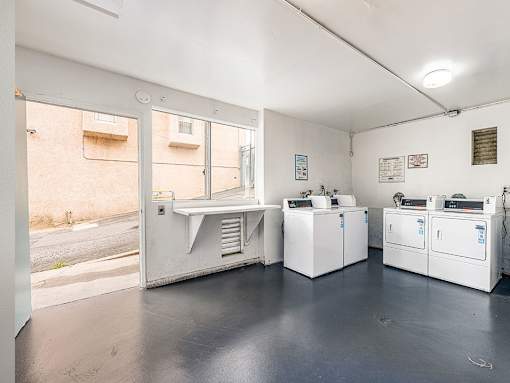 Clean on-site laundry room supporting both coin and app payment.