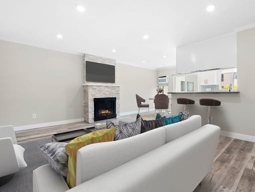 Hardwood floored living room with stone accented fireplace.
