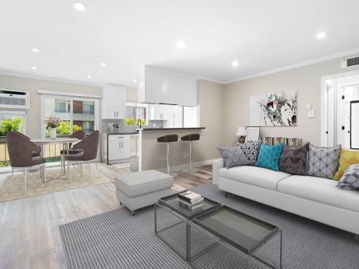 Hardwood floored living room with view of dining room, bar seating in kitchen, and balcony.