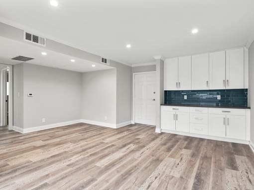 Hardwood floored living room with additional storage and countertop.