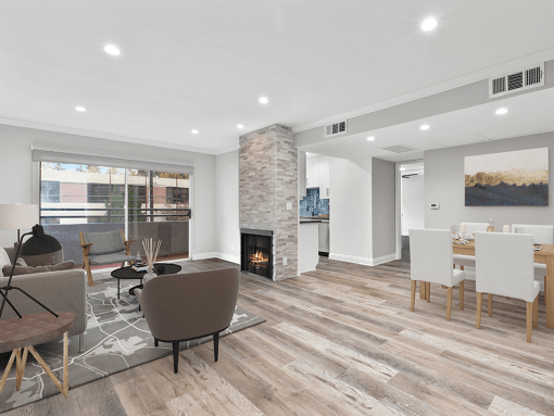 Hardwood floored living room with stone walled fireplace.