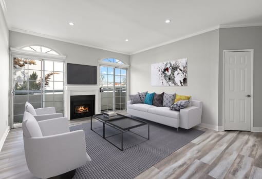 Large living room featuring hardwood floors and natural light providing adjacent patio.