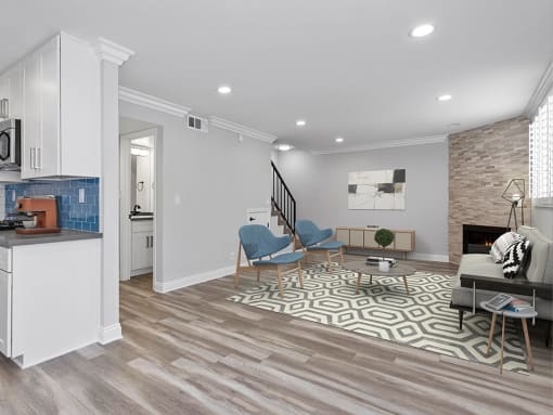 Brightly lit living room with stone walled fireplace.