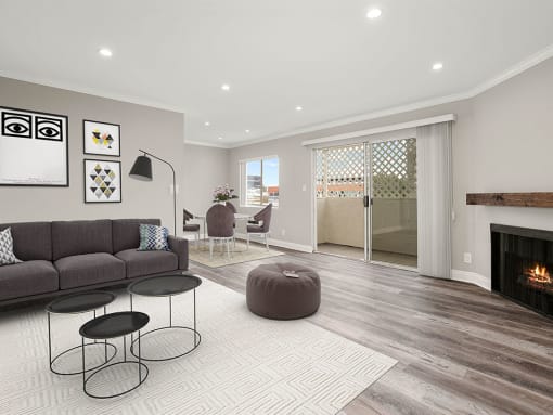 Living room with hardwood floors and view of balcony.