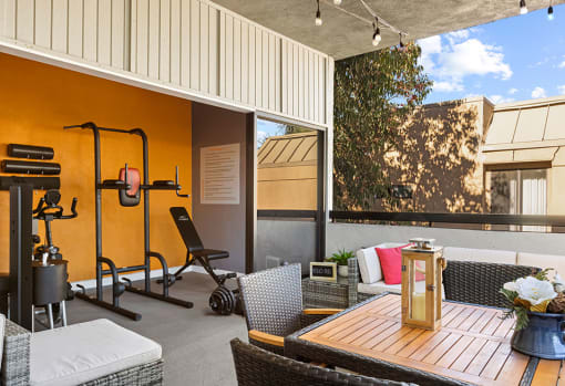 On-site fitness center with weight equipment and view of lounge.