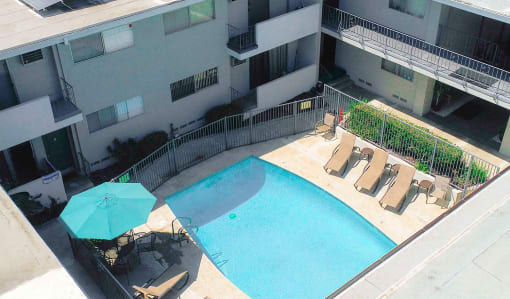Aerial image of gated pool with lounging area.