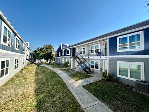A sunny day at a residential area with houses and a clear blue sky.