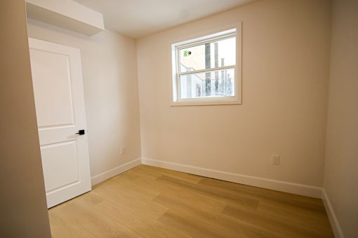 A room with a window and a door.