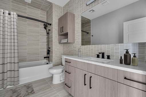 A modern bathroom with a white toilet and a white bathtub.