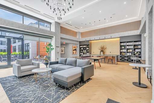 A modern living room with grey and wooden furniture.