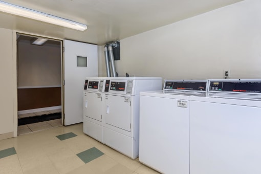 a laundry room with four washers and two dryers at Highland Ridge, Capitol Heights, 20743