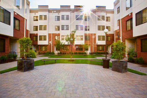 The Lofts at Middlesex in Middlesex NJ courtyard view with an elegant grassy area and various plants to welcome you
