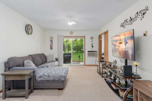A living room with a grey couch and a television.