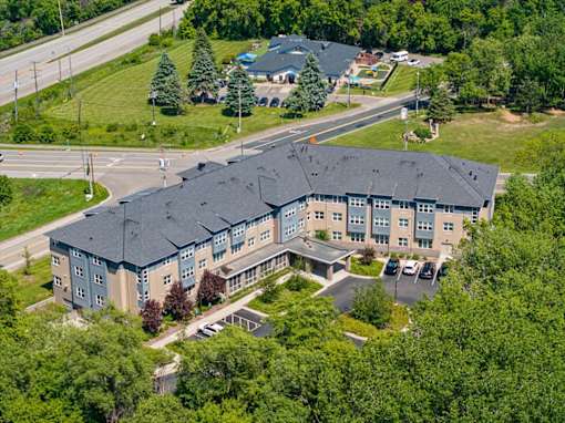 A large building with a parking lot in front of it.