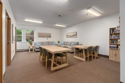 A room with a table and chairs in it.