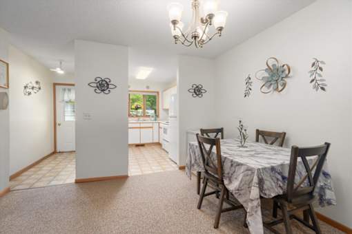 A dining room with a table set for four.