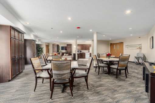 A dining room with a table set for six people.