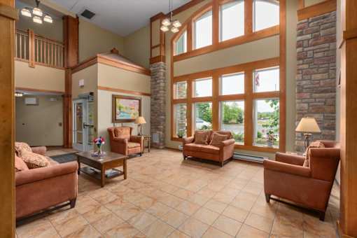 A living room with a couch, chairs, and a coffee table.