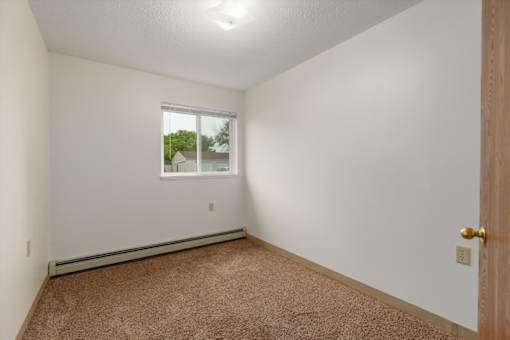 A room with a window and a door.