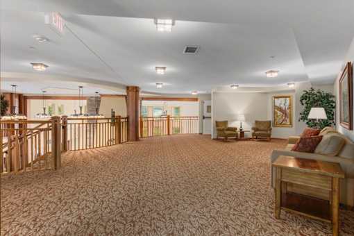A large room with a carpeted floor and furniture.