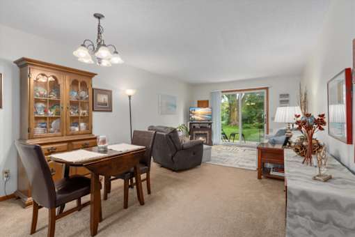 A dining room with a wooden table and chairs.