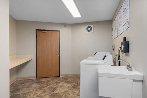 A bathroom with a sink, toiletries, and a door.