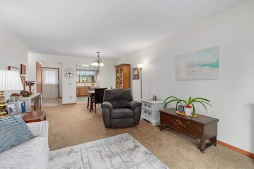 A living room with a grey couch and a brown coffee table.