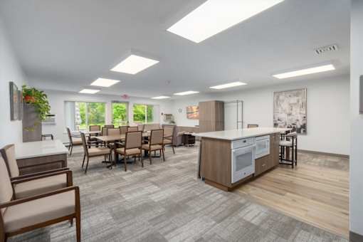 A modern kitchen with a dining table and chairs.