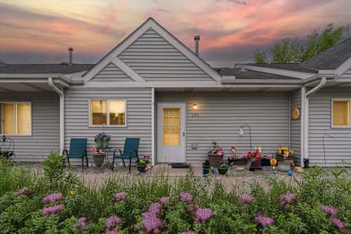 A house with a front porch and a garden in front.