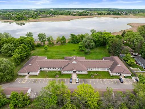 A large building with a parking lot in front of it.