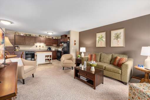 A living room with a couch, chairs, and a coffee table.