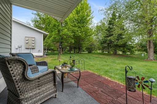 A patio with a chair and table is shown.