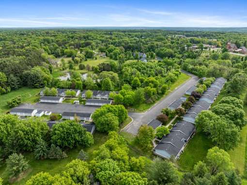 A bird's eye view of a residential area with houses and trees.