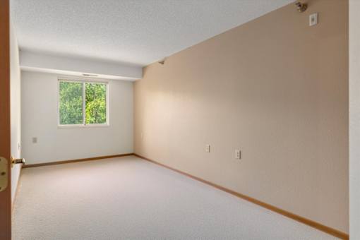 A room with a window and a door.