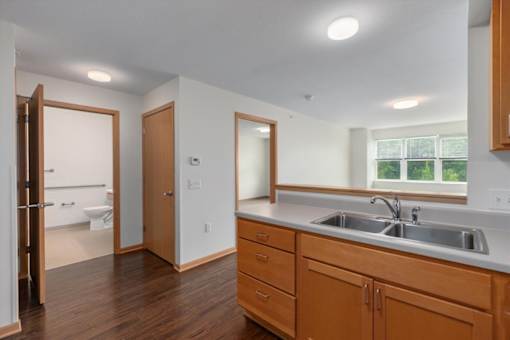A kitchen with wooden cabinets and a white countertop.