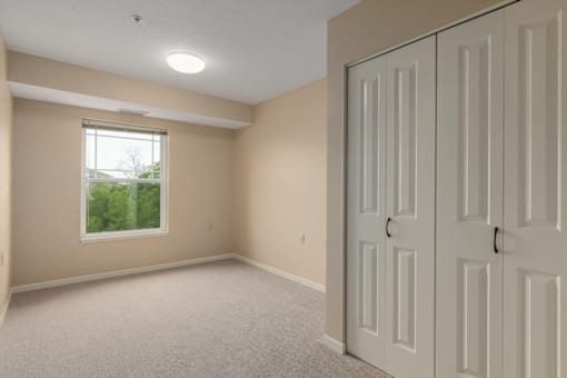 A room with a window and a door.