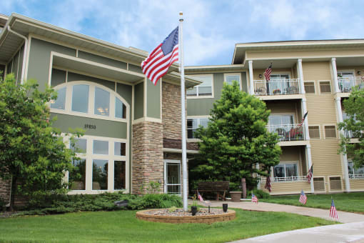an flag on a pole in front of an apartment building