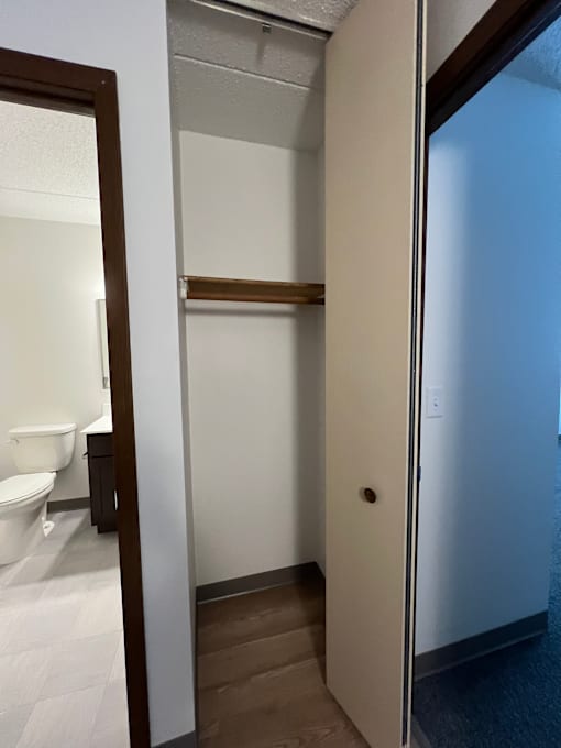 A white door is open to a bathroom.