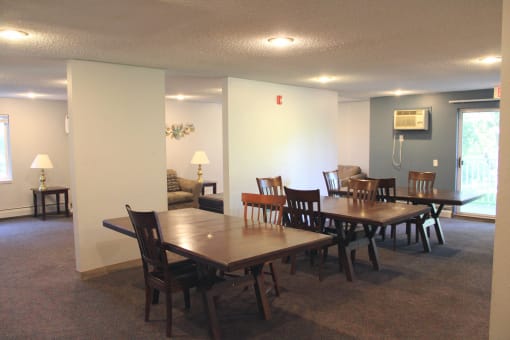 a dining room and living room with a table and chairs