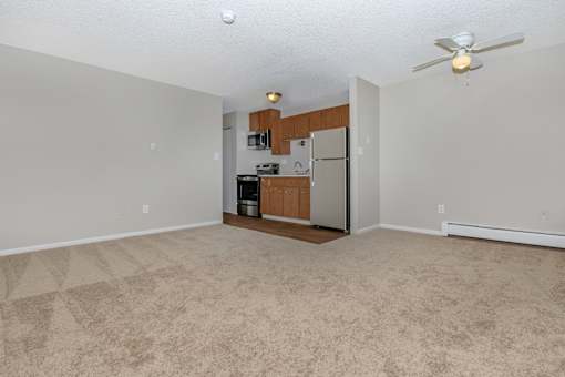A kitchen area with a refrigerator, microwave, and oven.