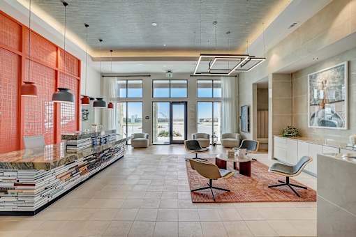 A modern office lobby with a glass wall and a reception desk.