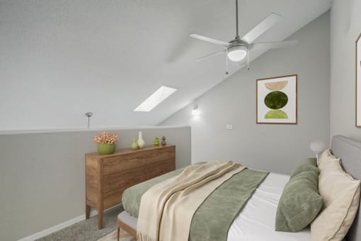 an attic bedroom with a bed and a ceiling fan