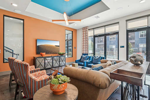 A living room with orange walls and furniture.