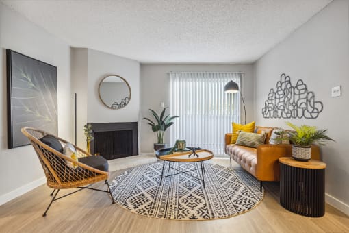 a living room with a brown couch and yellow pillows