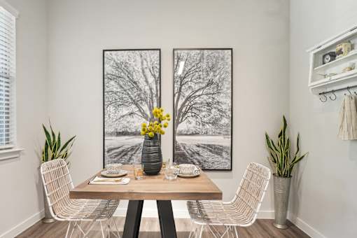 A dining room with a wooden table and chairs.