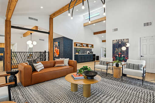 A living room with a brown sofa and a coffee table.
