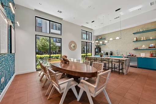 A modern dining room with a large table and chairs.