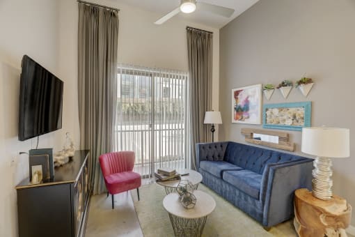 a living room with a blue couch and a tv
