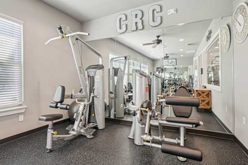 A gym with a variety of equipment including a leg press machine.